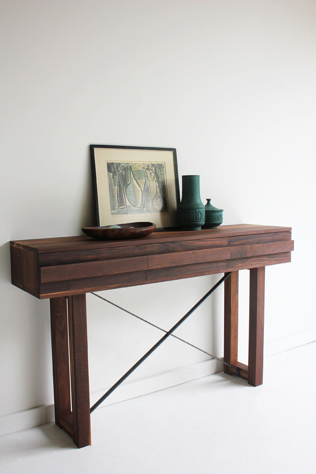Craft Associates® Console Table in luxury mid century modern walnut, full room view styled with framed art and ceramic accents