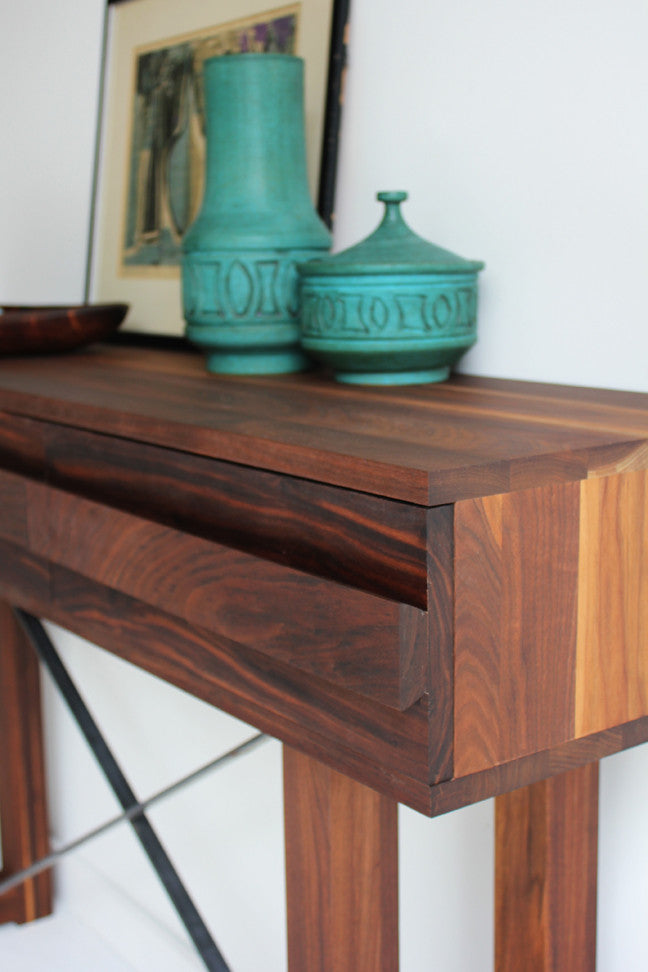 Craft Associates® Console Table in luxury mid century modern walnut, corner detail styled with decorative ceramics and framed art