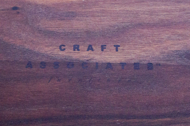 Close-up of the Craft Associates® branded stamp burned into the underside of the walnut Console Table