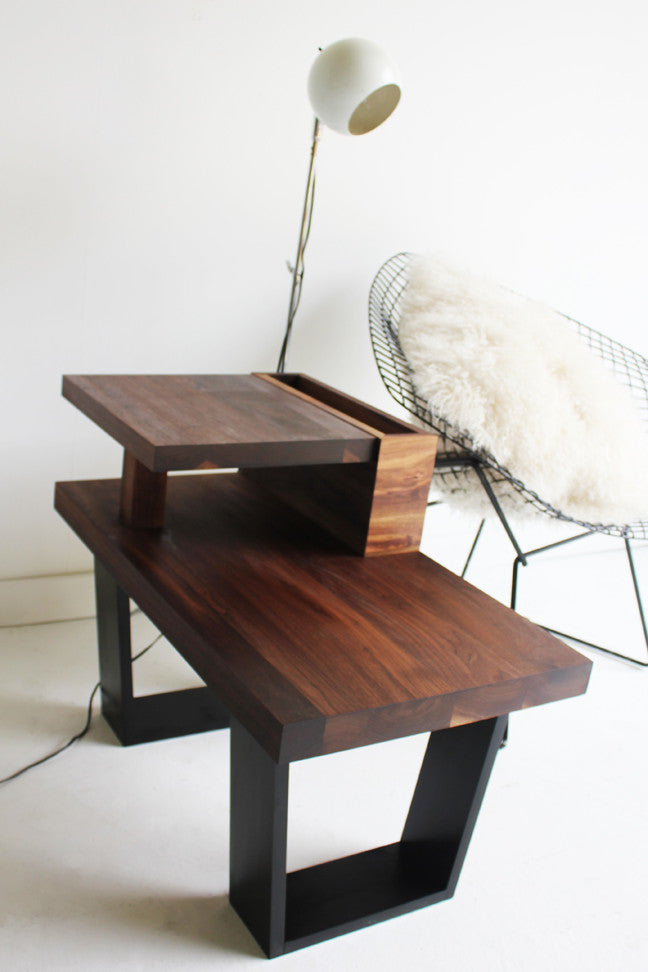 Craft Associates® End Table in luxury mid century modern walnut, styled beside a wire lounge chair and floor lamp
