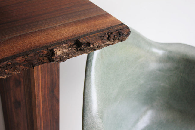 Close-up of the Live Edge console's raw walnut bark edge, showing the natural grain and texture