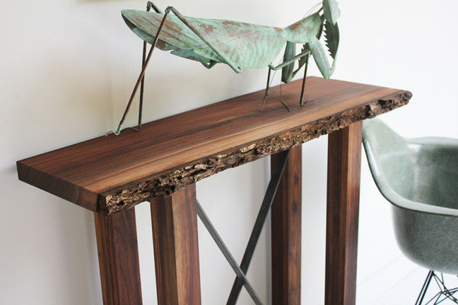 Craft Associates® Live Edge console in luxury mid century modern walnut, top-down view of the natural-edge tabletop with a sculptural accent piece